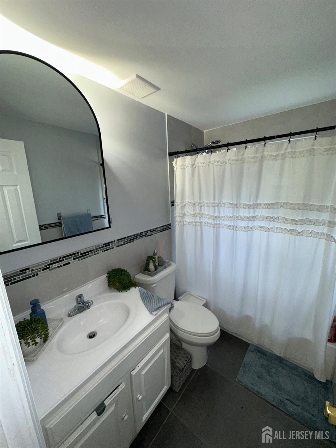 1019 Main Street Fords, NJ 08863 - Photo 13 of 20 a bathroom with a sink and a mirror