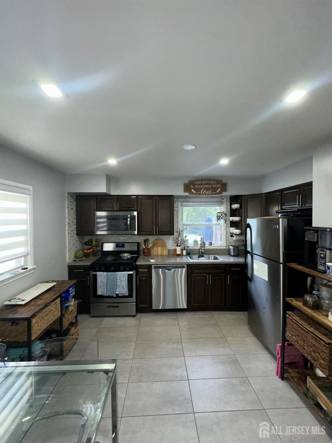 1019 Main Street Fords, NJ 08863 - Photo 8 of 20 a kitchen with a refrigerator and a stove top oven
