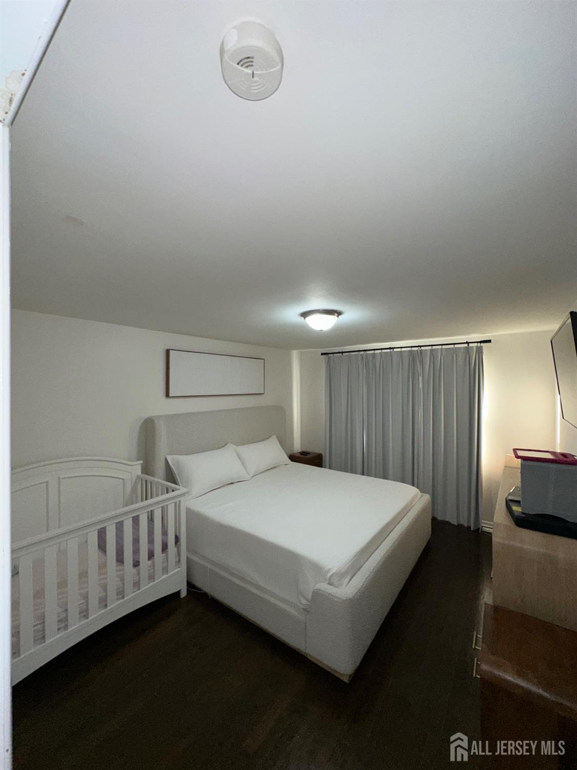 1019 Main Street Fords, NJ 08863 - Photo 10 of 20 a bedroom with a bed and a night stand