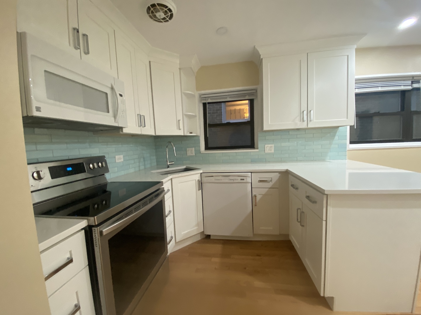 501 Sheridan Road, Unit A1 Evanston, IL 60202 - Photo 15 of 30 a kitchen with white cabinets and appliances