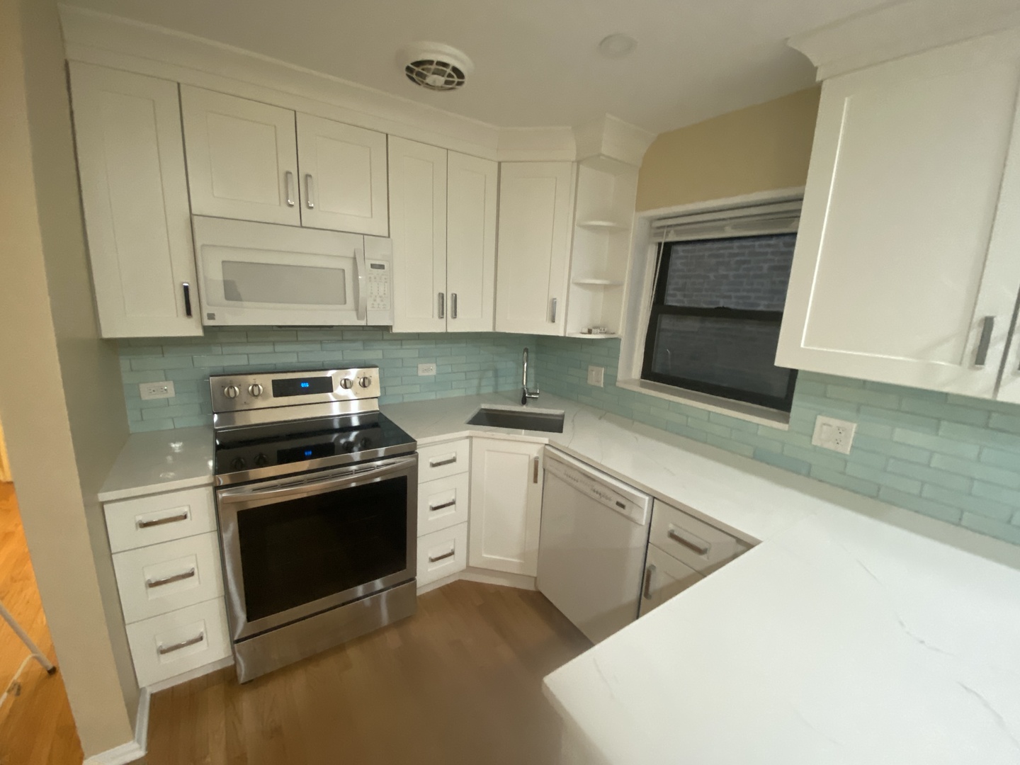 501 Sheridan Road, Unit A1 Evanston, IL 60202 - Photo 18 of 30 a kitchen with granite countertop white cabinets and stainless steel appliances