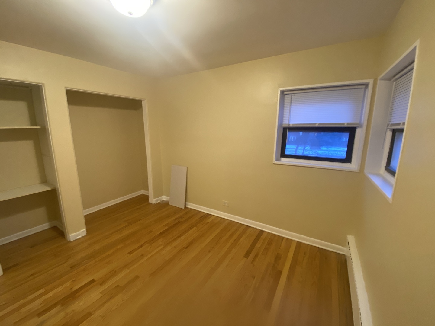 501 Sheridan Road, Unit A1 Evanston, IL 60202 - Photo 21 of 30 a view of an empty room with wooden floor and a window