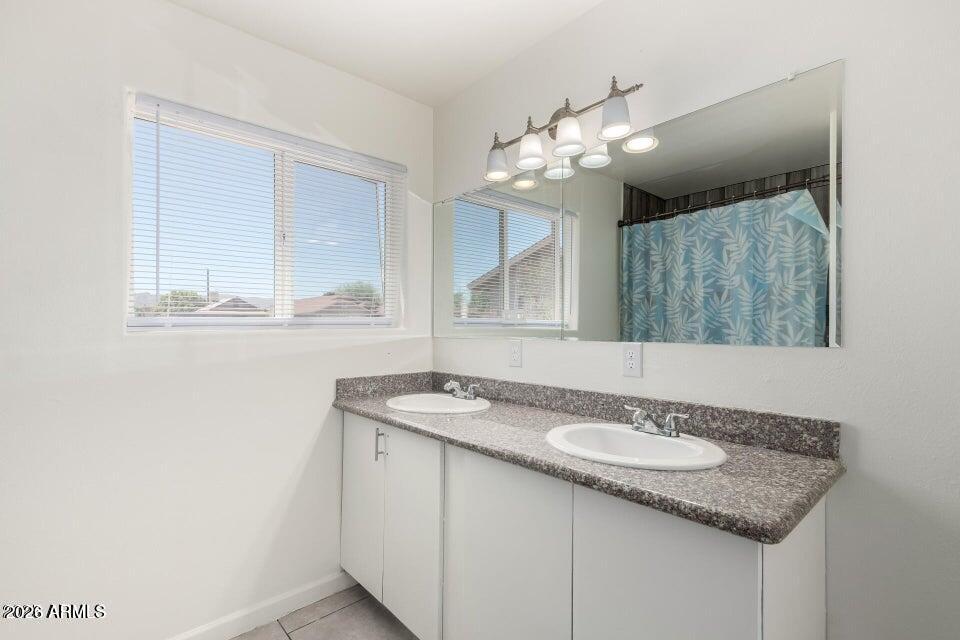 2828 East Chipman Road Phoenix, AZ 85040 - Photo 13 of 26 a bathroom with a granite countertop sink and a mirror