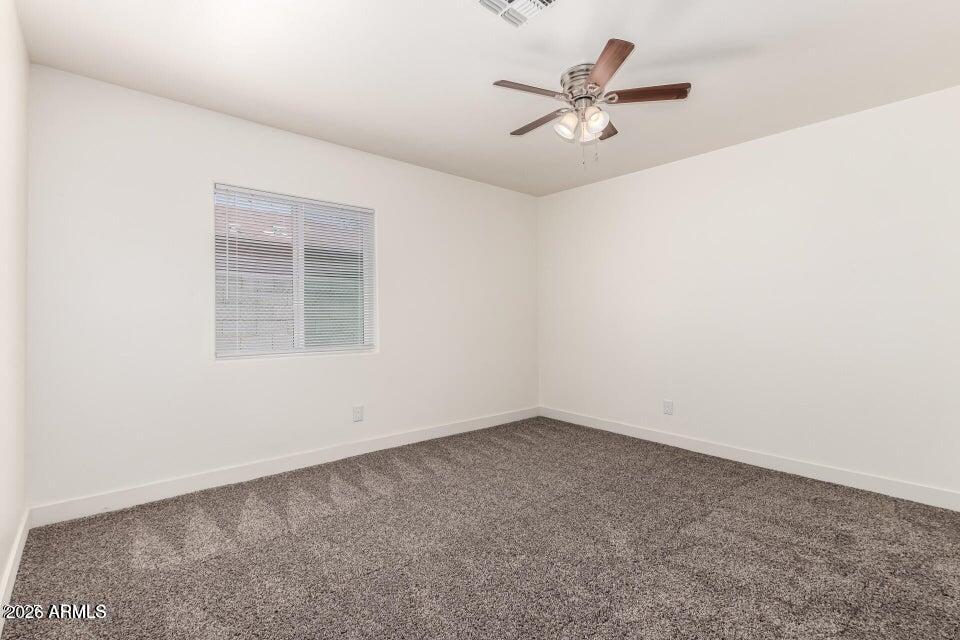 2828 East Chipman Road Phoenix, AZ 85040 - Photo 16 of 26 an empty room with a window and a fan