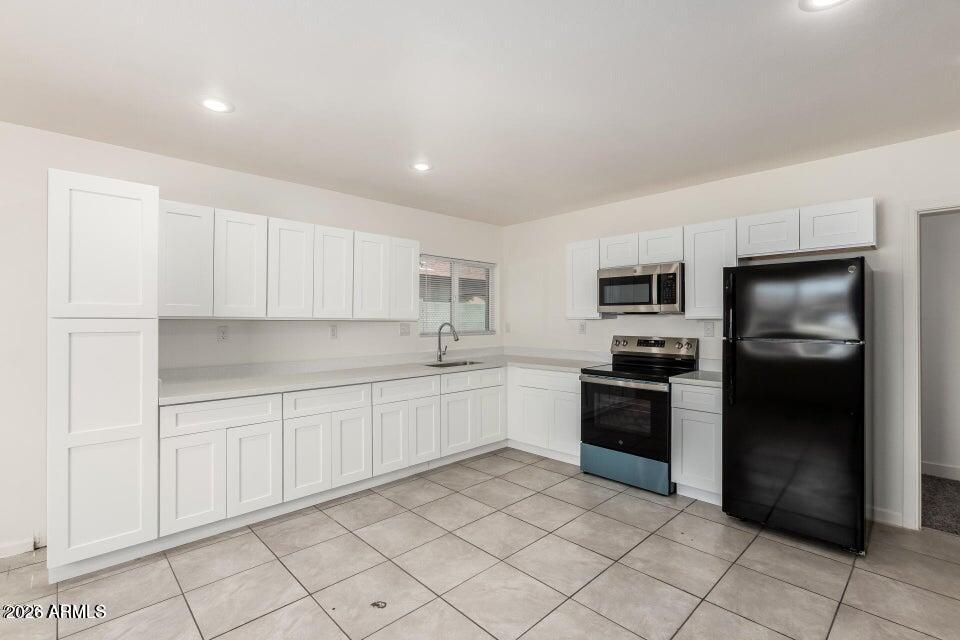 2828 East Chipman Road Phoenix, AZ 85040 - Photo 8 of 26 a kitchen with cabinets and stainless steel appliances