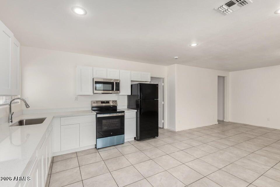 2828 East Chipman Road Phoenix, AZ 85040 - Photo 9 of 26 a kitchen with stainless steel appliances a refrigerator sink and stove