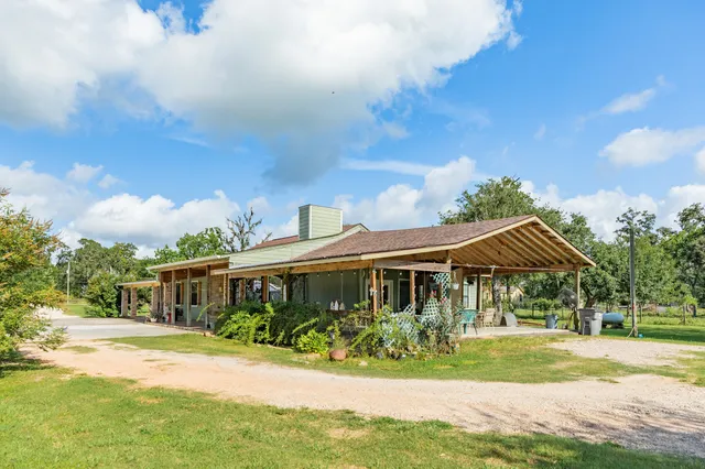 a front view of house with yard and green space