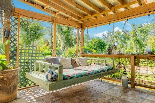 a view of patio with a table and chairs and potted plants