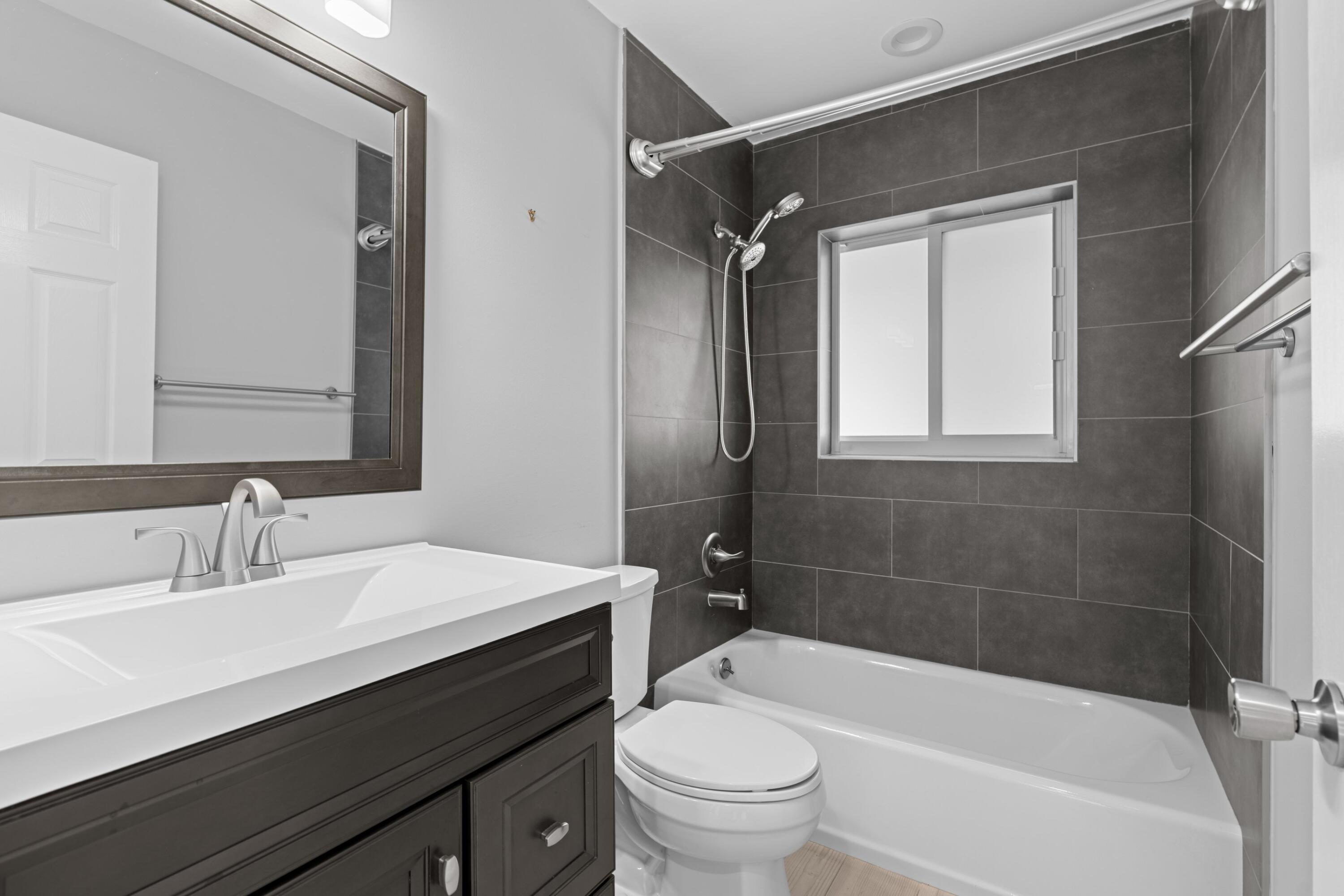 1431 Rudder Cove Wellington, FL 33414 - Photo 15 of 22 a bathroom with a sink a toilet a mirror and shower