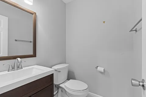 a white toilet sitting next to a bathroom sink