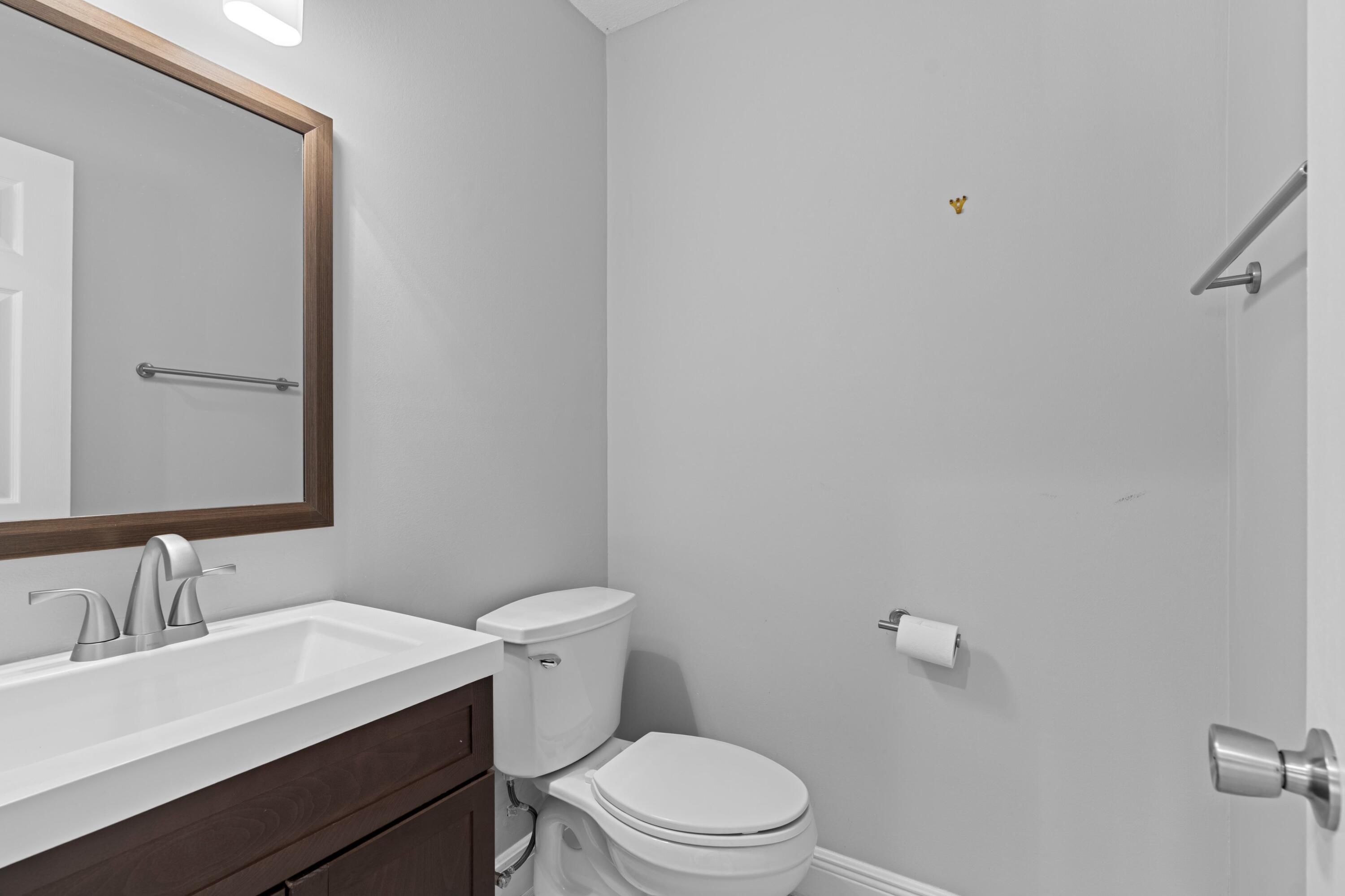 1431 Rudder Cove Wellington, FL 33414 - Photo 18 of 22 a white toilet sitting next to a bathroom sink