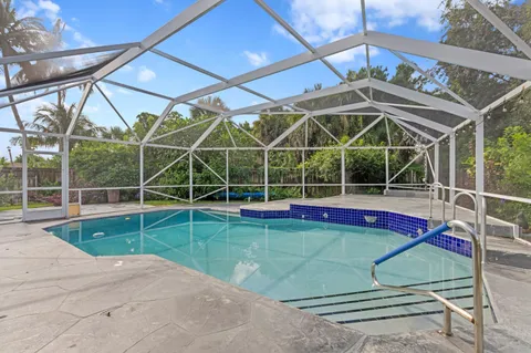 a view of a backyard with a swimming pool