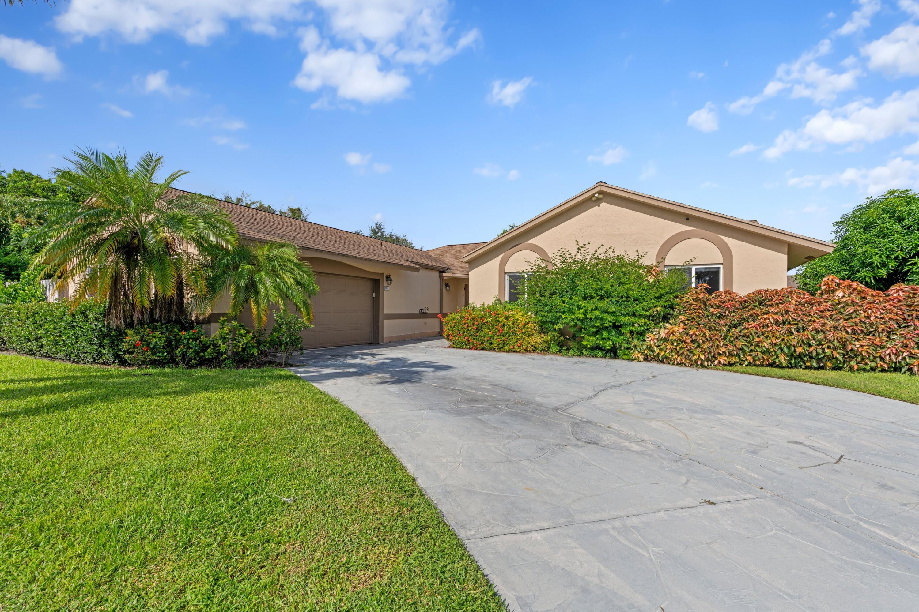 1431 Rudder Cove Wellington, FL 33414 - Photo 21 of 22 a front view of a house with garden
