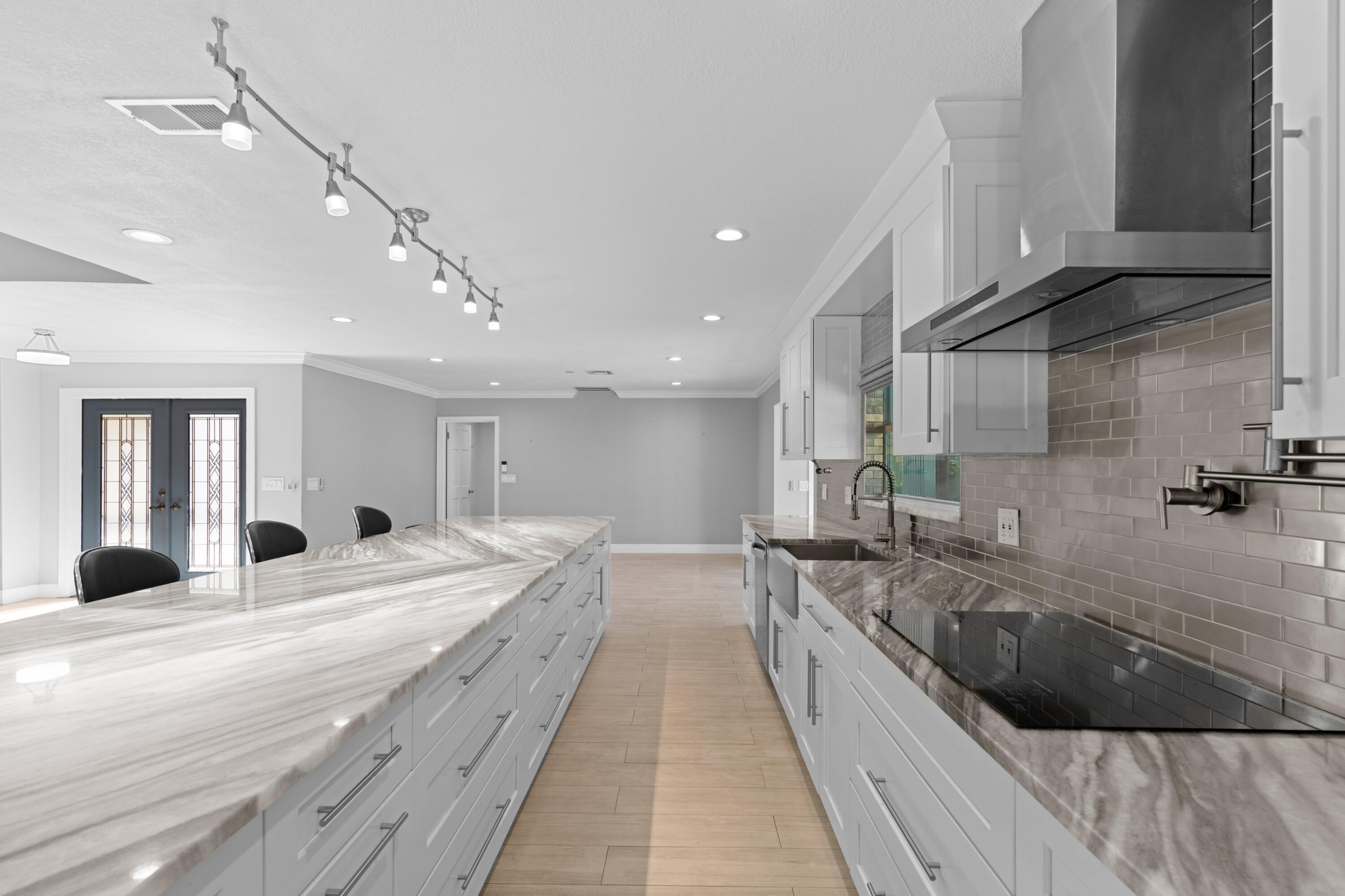 1431 Rudder Cove Wellington, FL 33414 - Photo 7 of 22 a large white kitchen with a large window