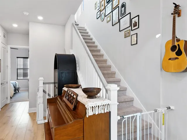 a view of entryway and hall with wooden floor