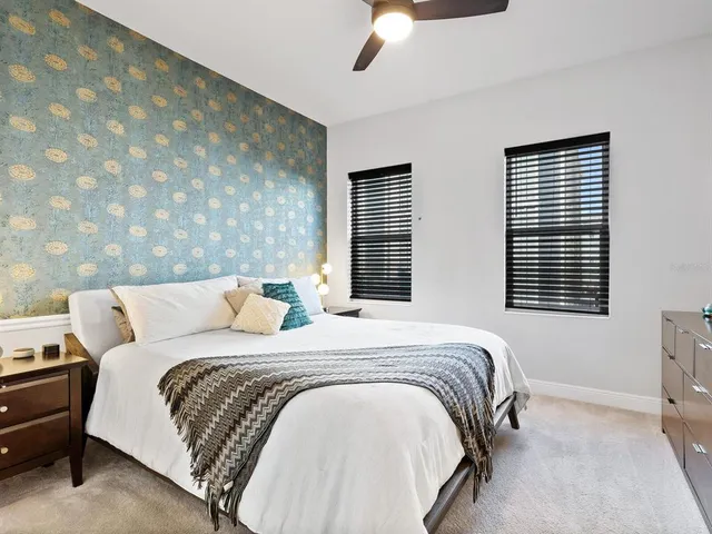 a bed sitting in a bedroom next to a window