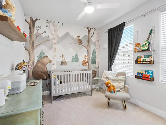 a bedroom with furniture and a book shelf