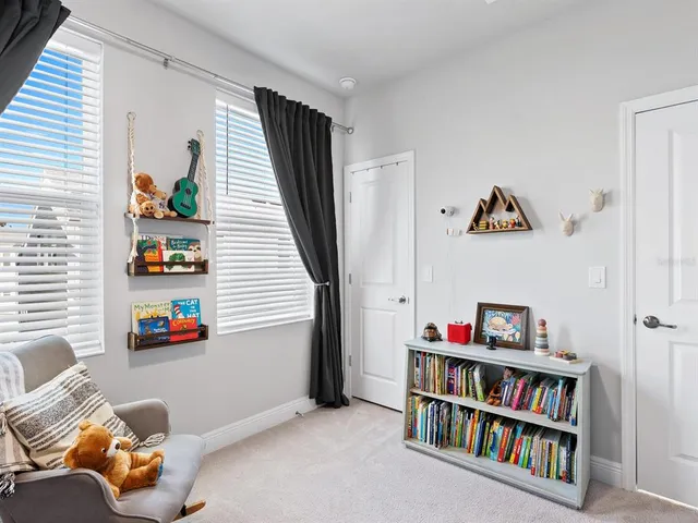 a living room with lots of books and a book shelf