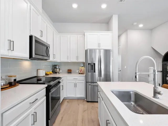 a kitchen with a sink cabinets and stainless steel appliances