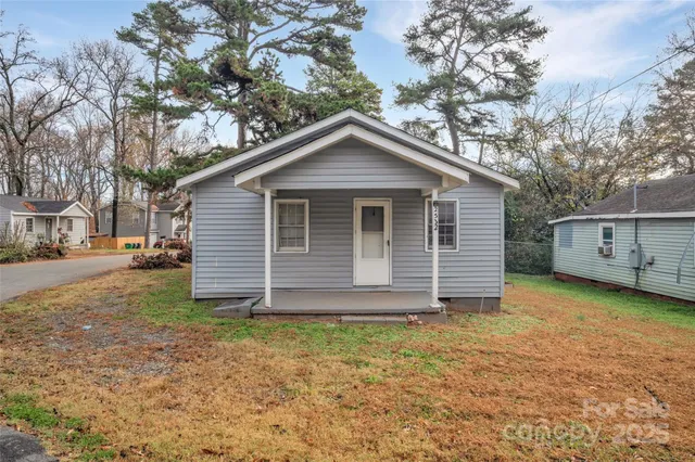 a view of a house with a yard and garage
