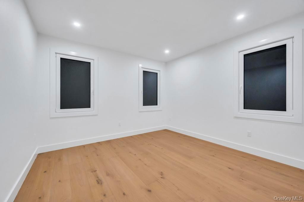 472 Farm Ranch Road East Bethpage, NY 11714 - Photo 16 of 26 a view of an empty room with wooden floor and a window