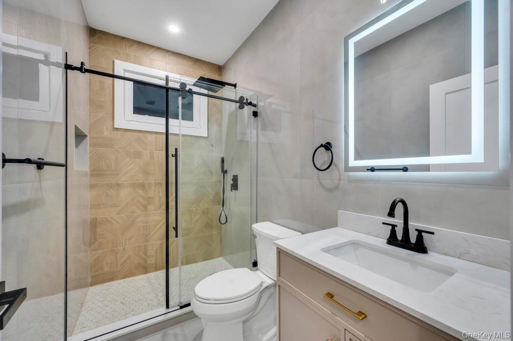 472 Farm Ranch Road East Bethpage, NY 11714 - Photo 22 of 26 a bathroom with a shower sink vanity mirror and toilet