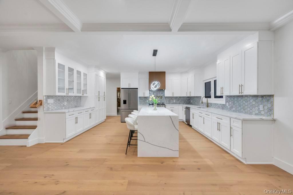 472 Farm Ranch Road East Bethpage, NY 11714 - Photo 3 of 26 a large white kitchen with cabinets and wooden floor