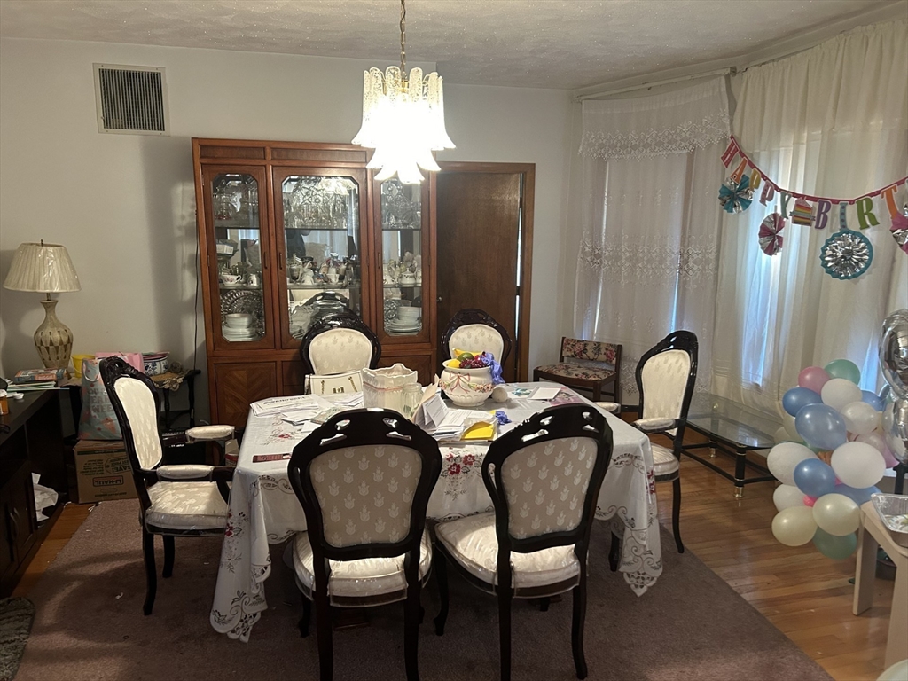 16 Hampshire Street Everett, MA 02149 - Photo 3 of 8 a view of a dining room with furniture and chandelier