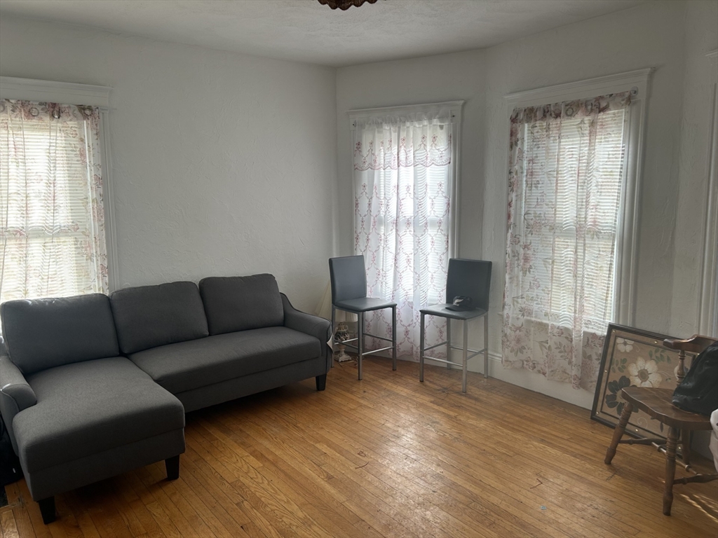 16 Hampshire Street Everett, MA 02149 - Photo 6 of 8 a living room with furniture and a window