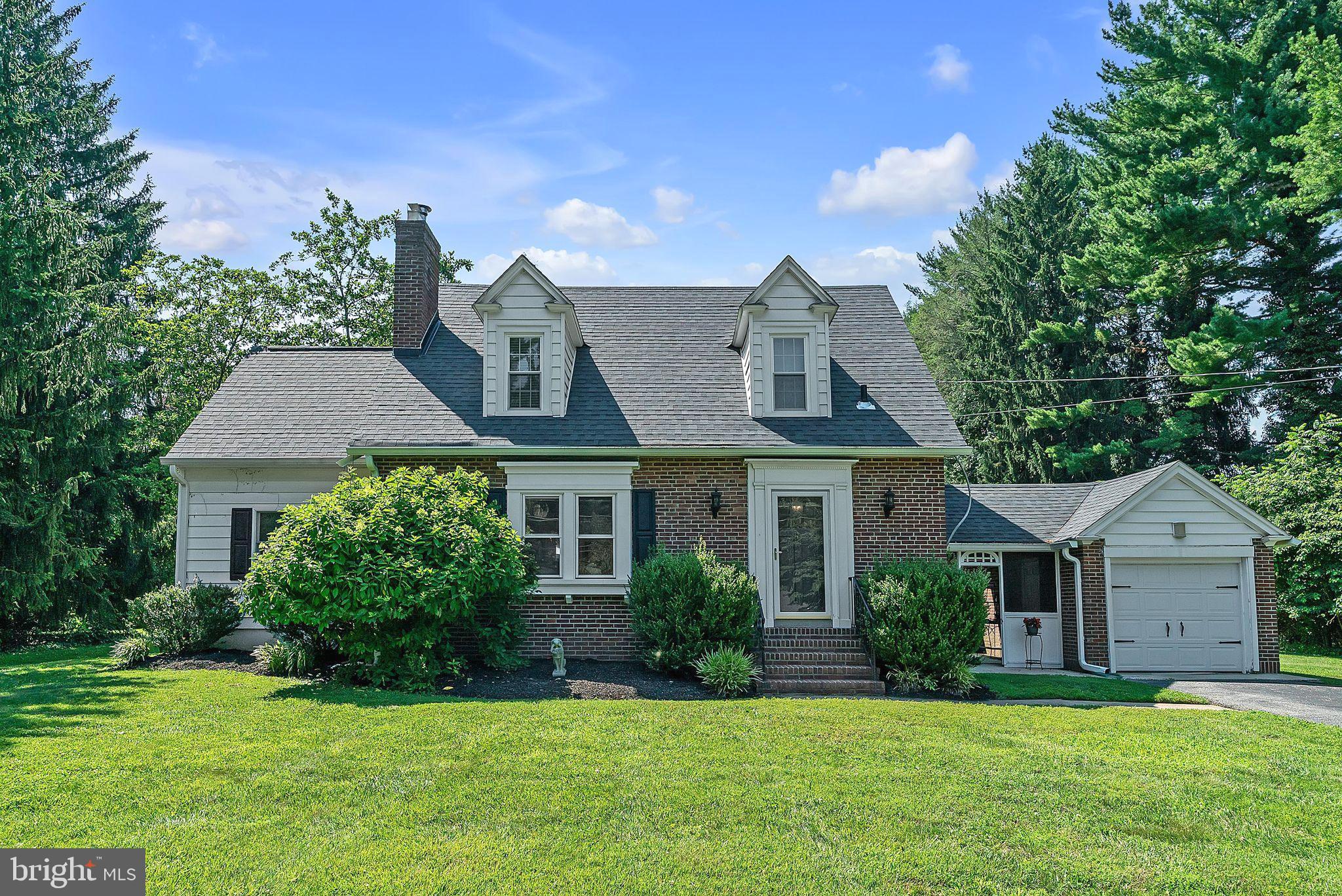 31 Rabbit Run Road Rose Valley, PA 19086 - Photo 1 of 35 a front view of a house with a yard and garage