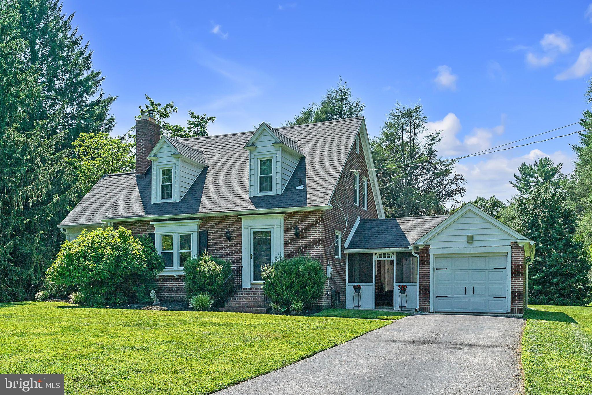 31 Rabbit Run Road Rose Valley, PA 19086 - Photo 2 of 35 a front view of a house with a yard and garage