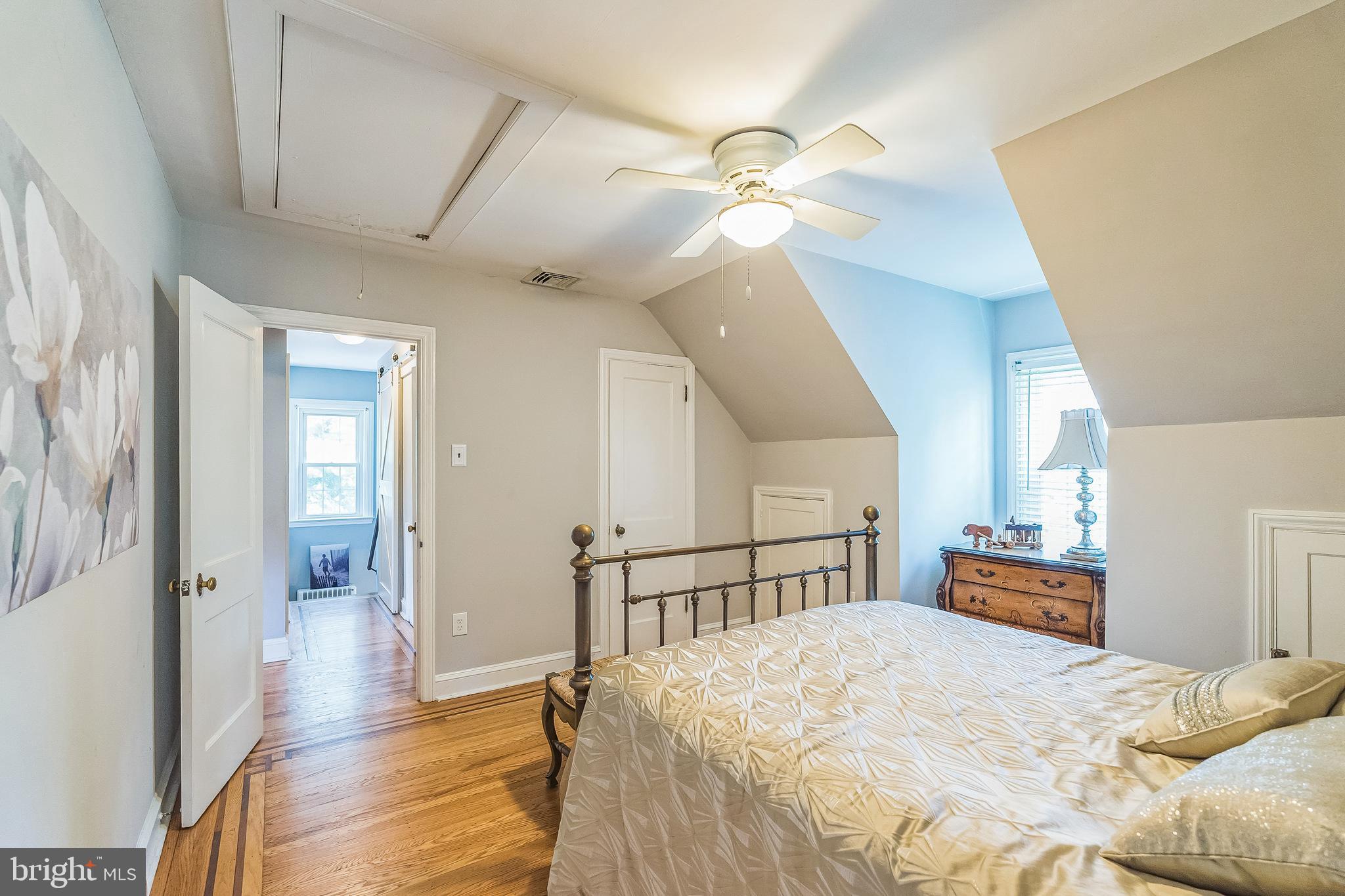 31 Rabbit Run Road Rose Valley, PA 19086 - Photo 22 of 35 a bedroom with a bed and a chandelier