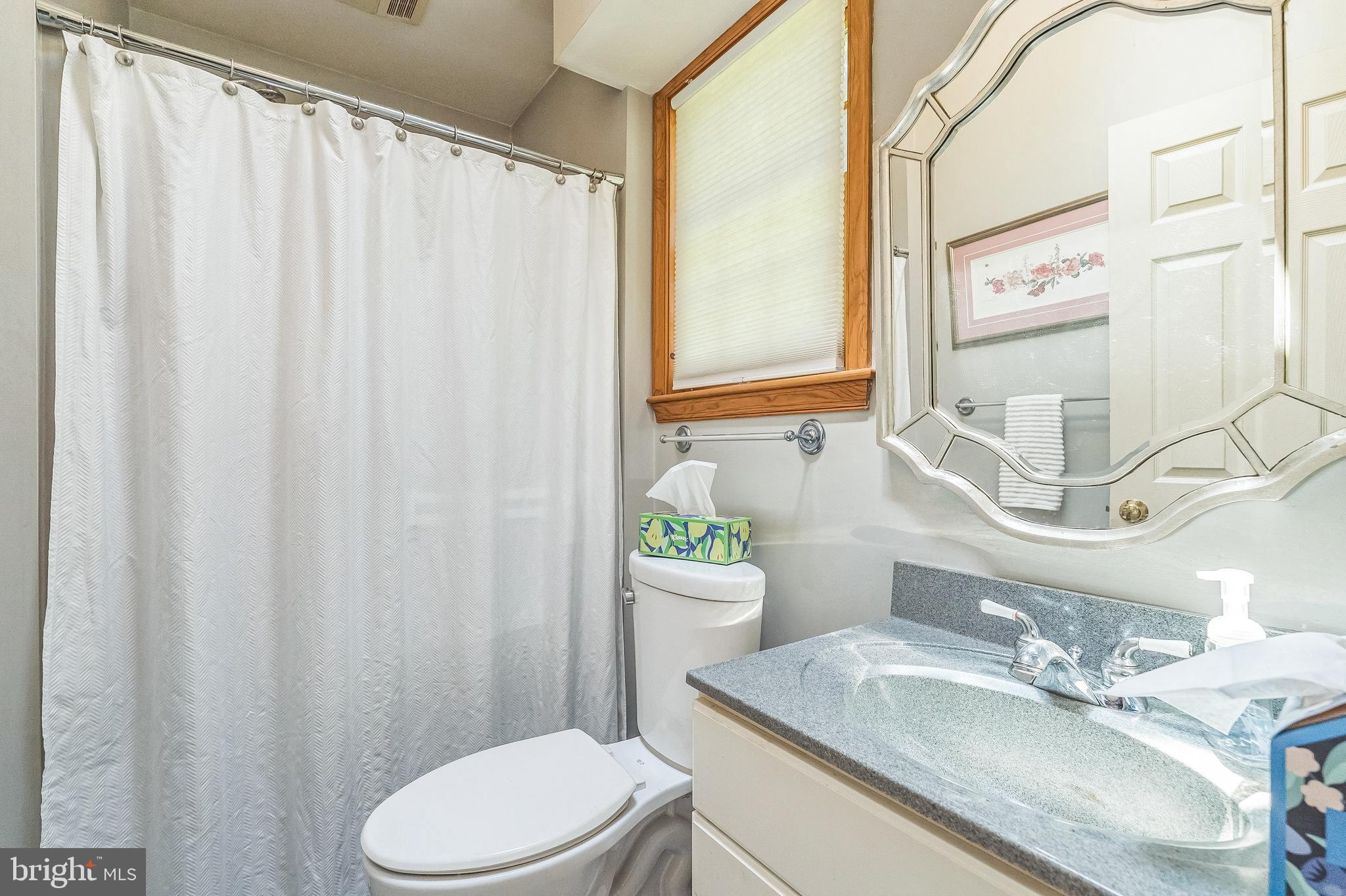 31 Rabbit Run Road Rose Valley, PA 19086 - Photo 29 of 35 a bathroom with a granite countertop sink and a mirror