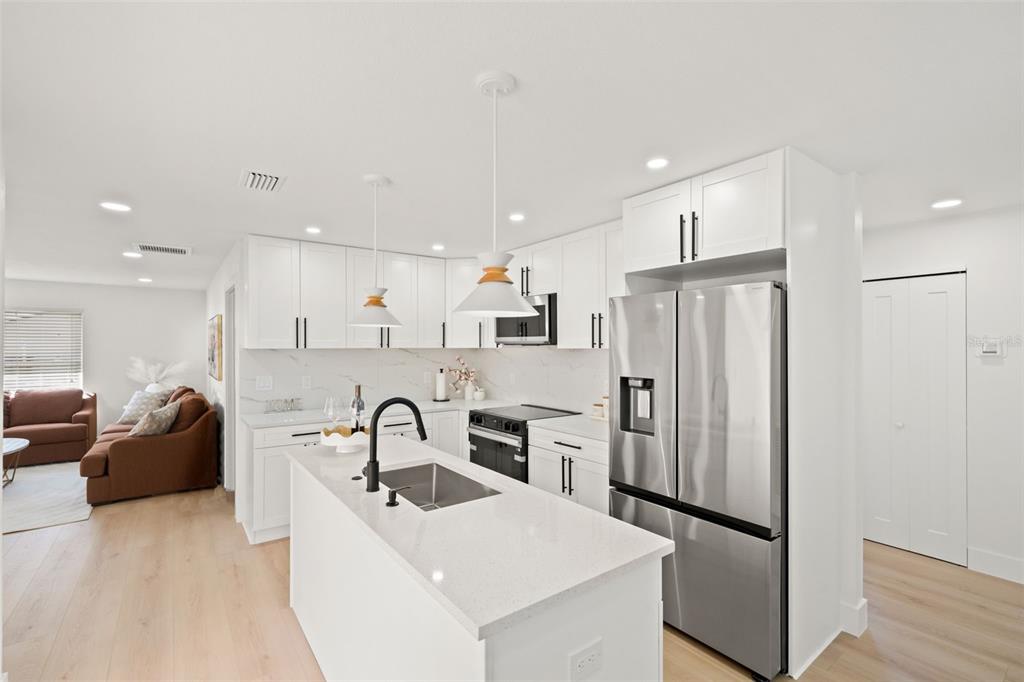 12671 115th Street Largo, FL 33778 - Photo 11 of 39 a kitchen with stainless steel appliances granite countertop a refrigerator and a sink