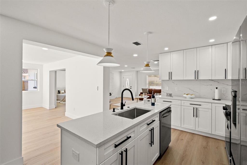 12671 115th Street Largo, FL 33778 - Photo 12 of 39 a kitchen with a sink white cabinets and stainless steel appliances