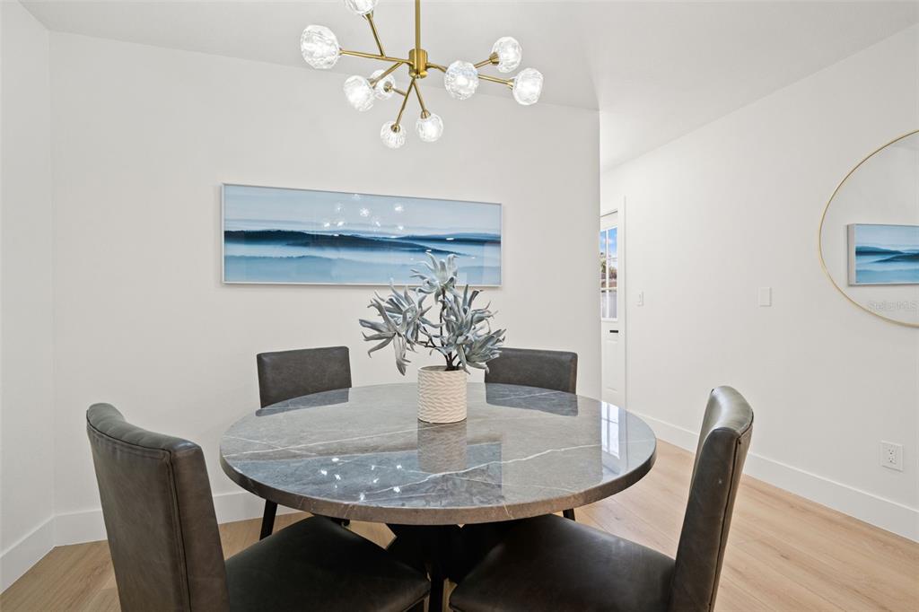 12671 115th Street Largo, FL 33778 - Photo 15 of 39 a view of a dining room with furniture and wooden floor