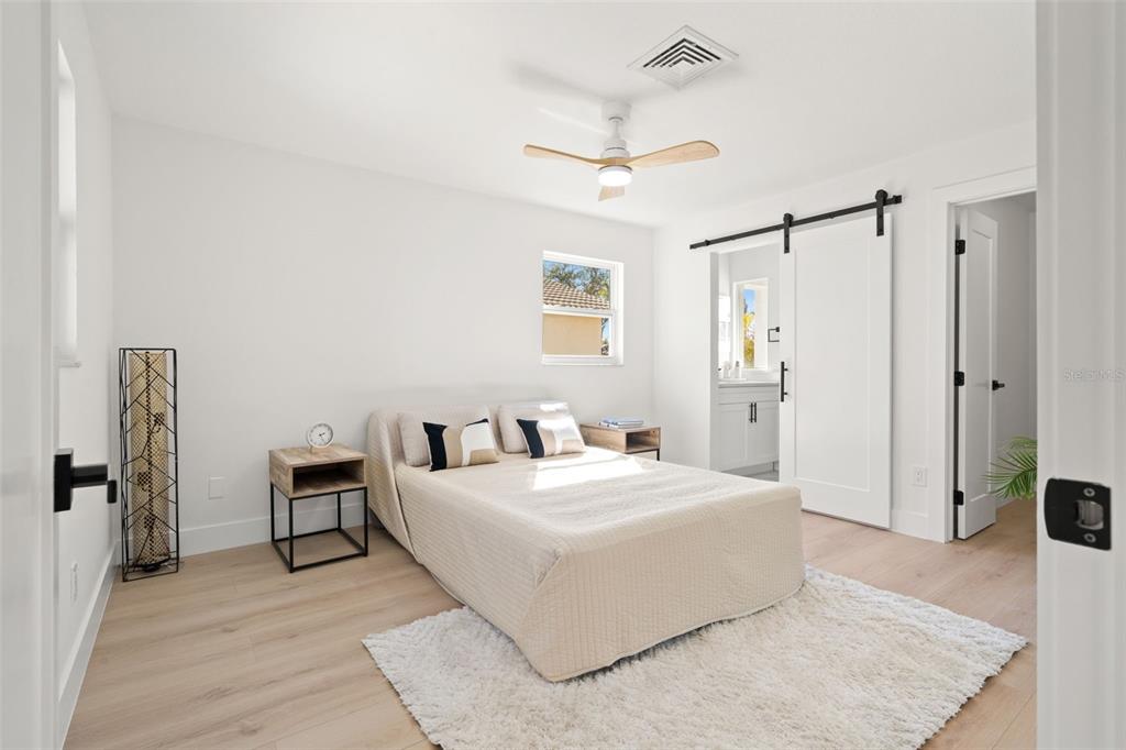 12671 115th Street Largo, FL 33778 - Photo 16 of 39 a bedroom with a bed and a table