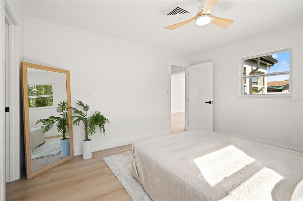 12671 115th Street Largo, FL 33778 - Photo 18 of 39 a bedroom with a large bed and a potted plant