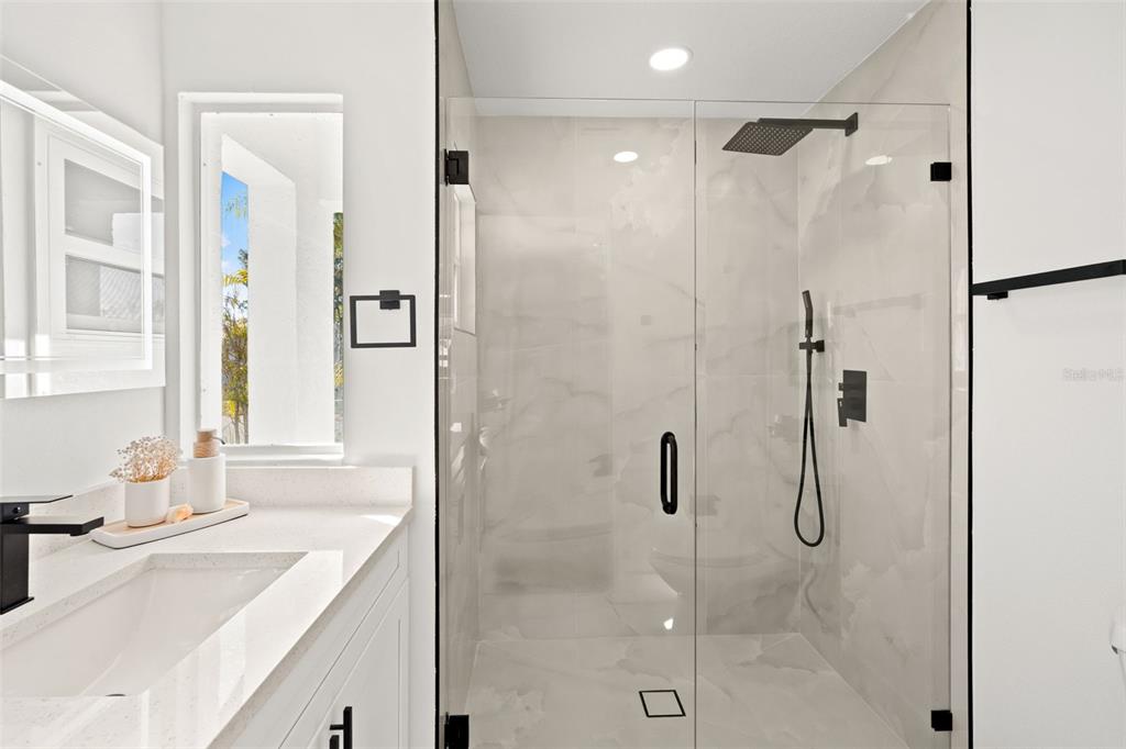 12671 115th Street Largo, FL 33778 - Photo 19 of 39 a bathroom with a shower sink and mirror