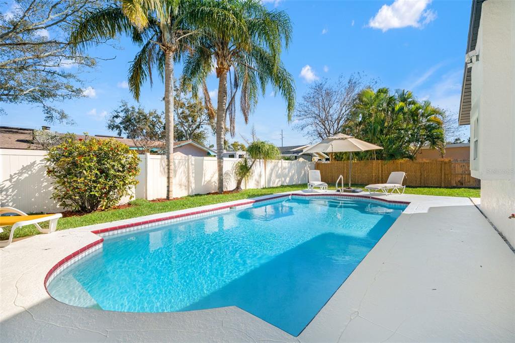 12671 115th Street Largo, FL 33778 - Photo 2 of 39 a view of a swimming pool with a chair