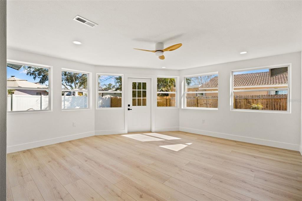 12671 115th Street Largo, FL 33778 - Photo 21 of 39 a view of an empty room with window and wooden floor