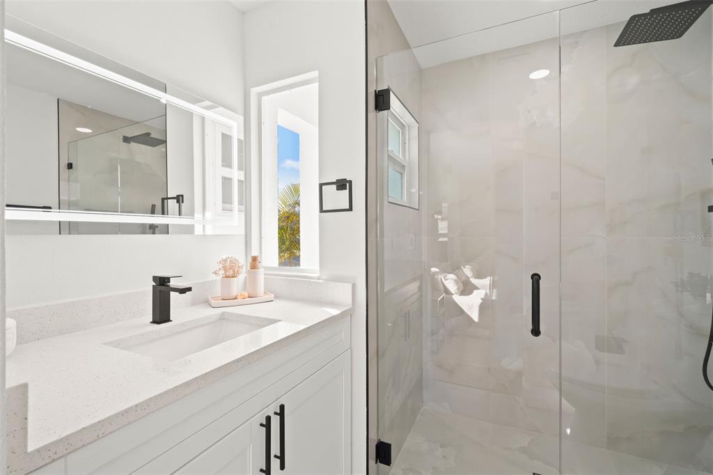 12671 115th Street Largo, FL 33778 - Photo 24 of 39 a bathroom with a sink and mirror