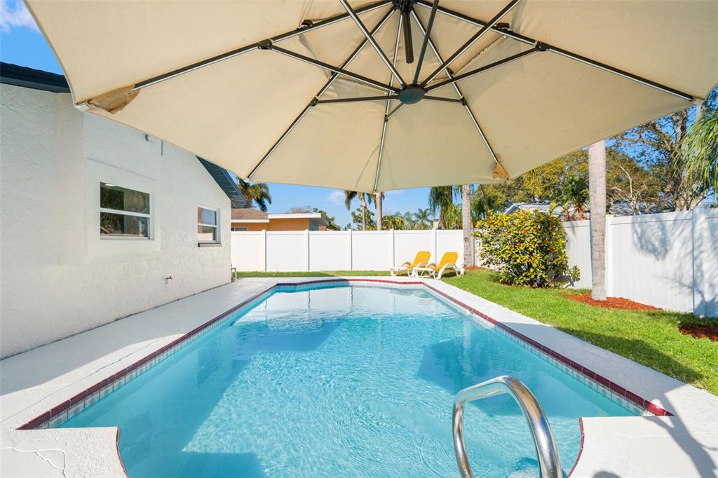 12671 115th Street Largo, FL 33778 - Photo 32 of 39 a view of a backyard with a tub and chairs