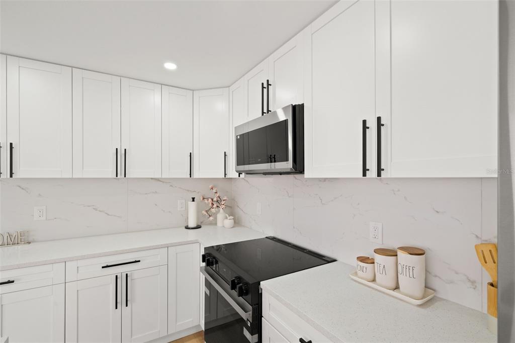 12671 115th Street Largo, FL 33778 - Photo 9 of 39 a kitchen with a sink cabinets and stove