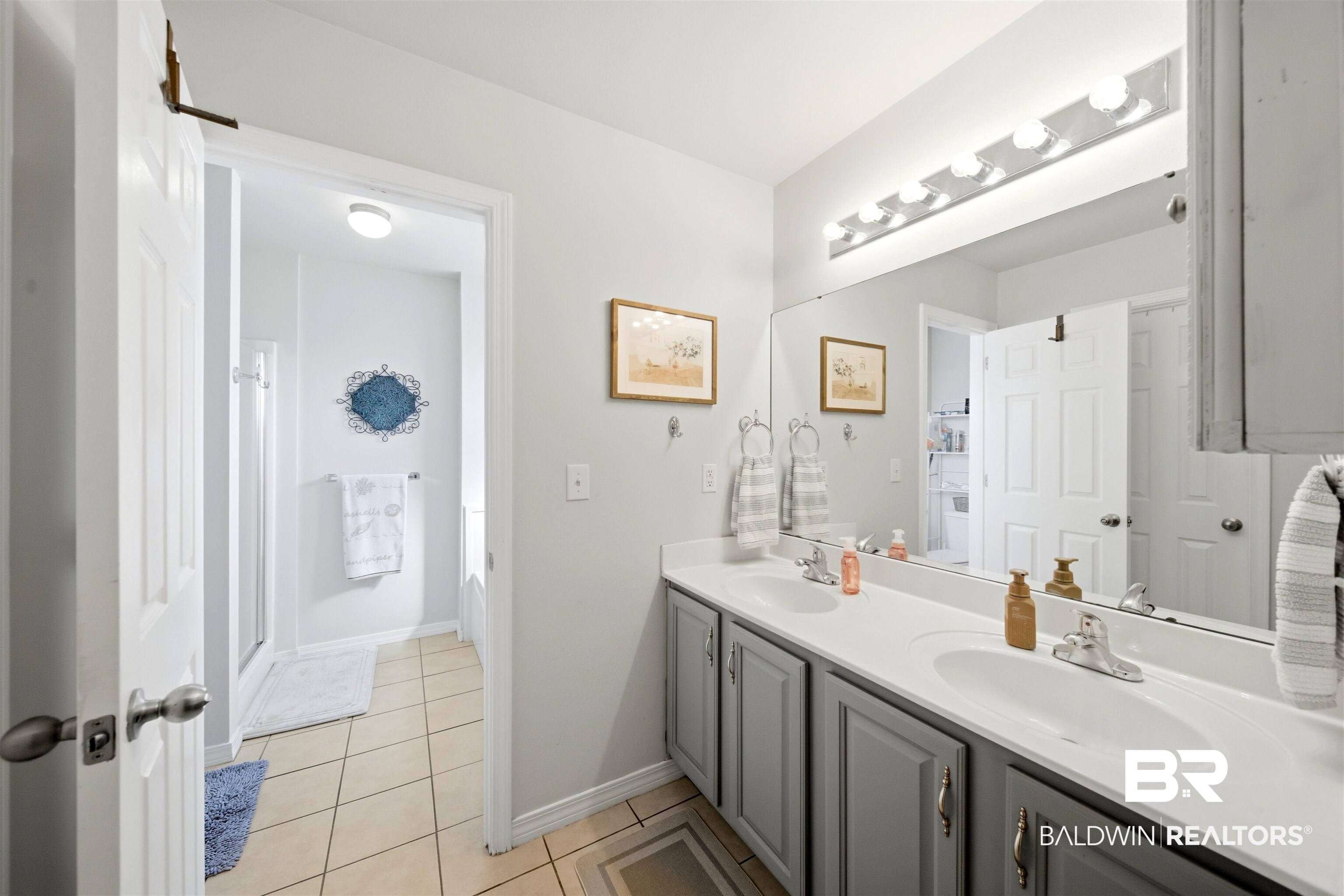 1901 Colorado Court Foley, AL 36535 - Photo 11 of 23 Bathroom with double vanity, light tile patterned floors, and a shower stall