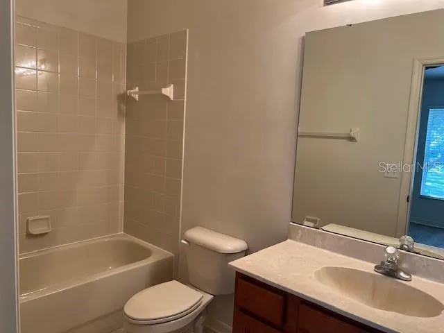 a bathroom with a sink toilet vanity and shower