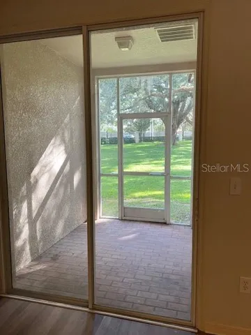 a view of a room with a floor to ceiling window and outside view