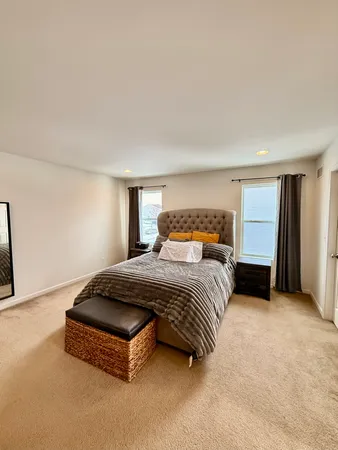 a spacious bedroom with a bed and a cabinets