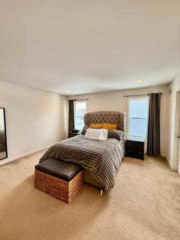 a spacious bedroom with a bed and a cabinets