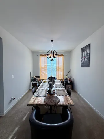 a dining room with table and chairs